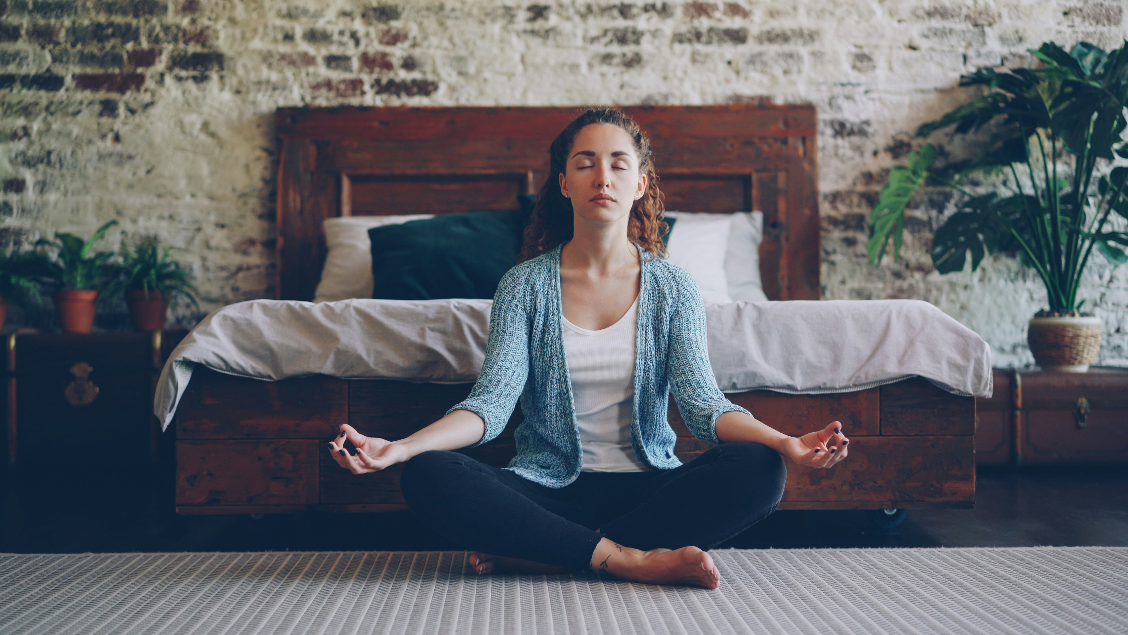 A person sleeping deeply and peacefully in soft natural light, representing the restorative goal behind the sleepmaxxing trend